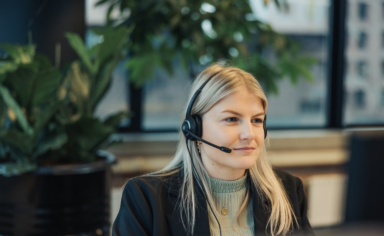 Girl with headset looking at screen