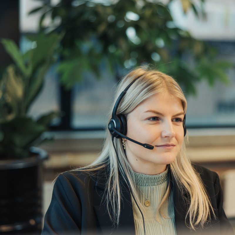 Girl with headset looking at screen