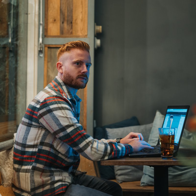 MAn behind laptop