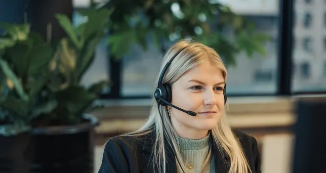 Girl with headset looking at screen